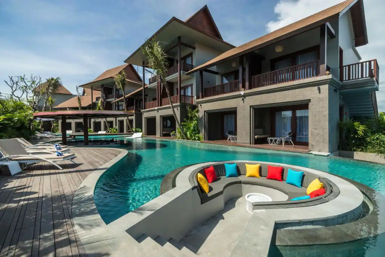 Boutique hotel pool deck with loungers and tropical planting
